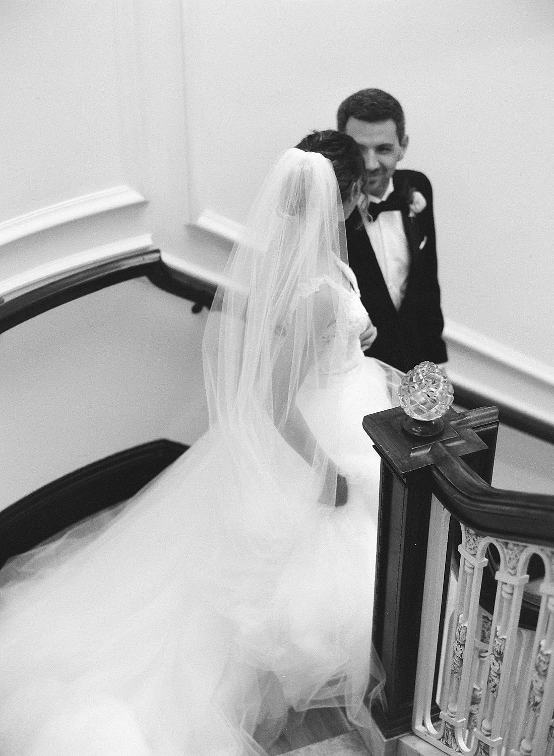 Bride and groom walking down the stairs at their DAR Constitution Hall wedding.