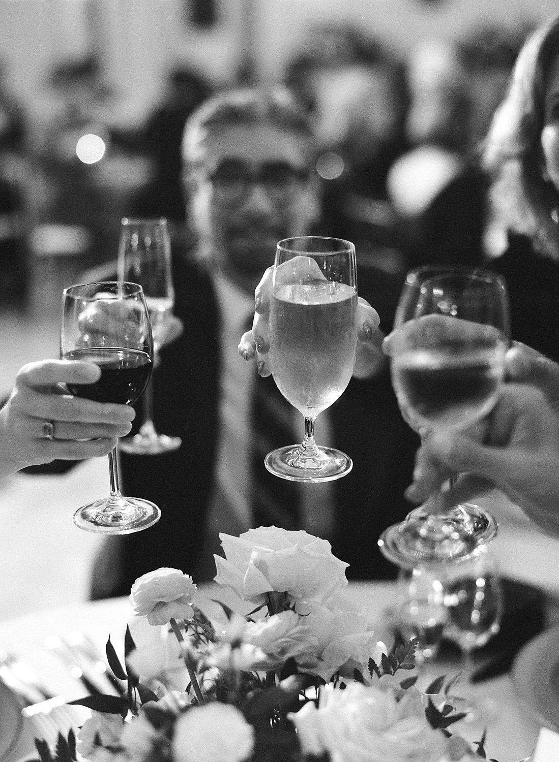 Guests toasting to speeches at a DAR Constitution Hall wedding.