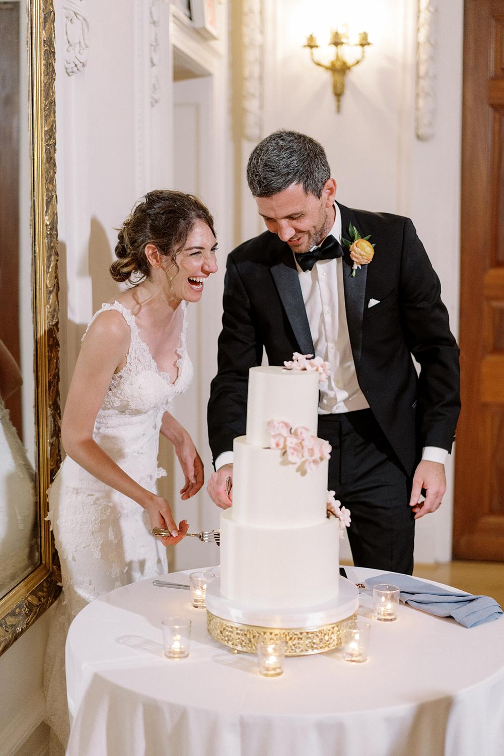 Bride and groom cutting a cake during their reception at DAR Constitution Hall.