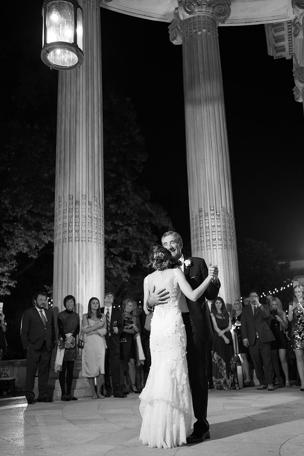 Father and daughter sharing a dance under the columns of the DAR Constitution hall during the reception.