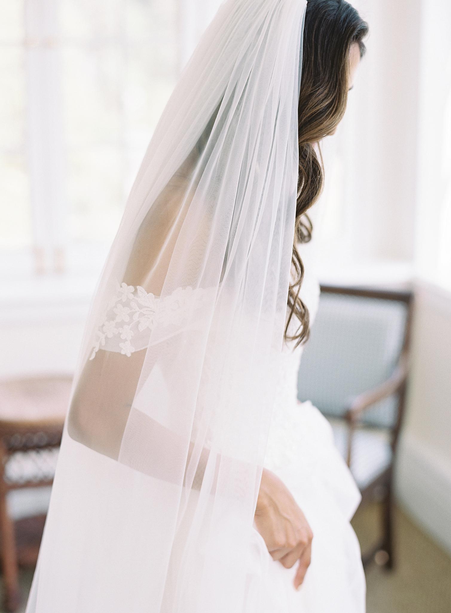 Bride in veil walking out the door to her Omni Homestead Resort wedding.