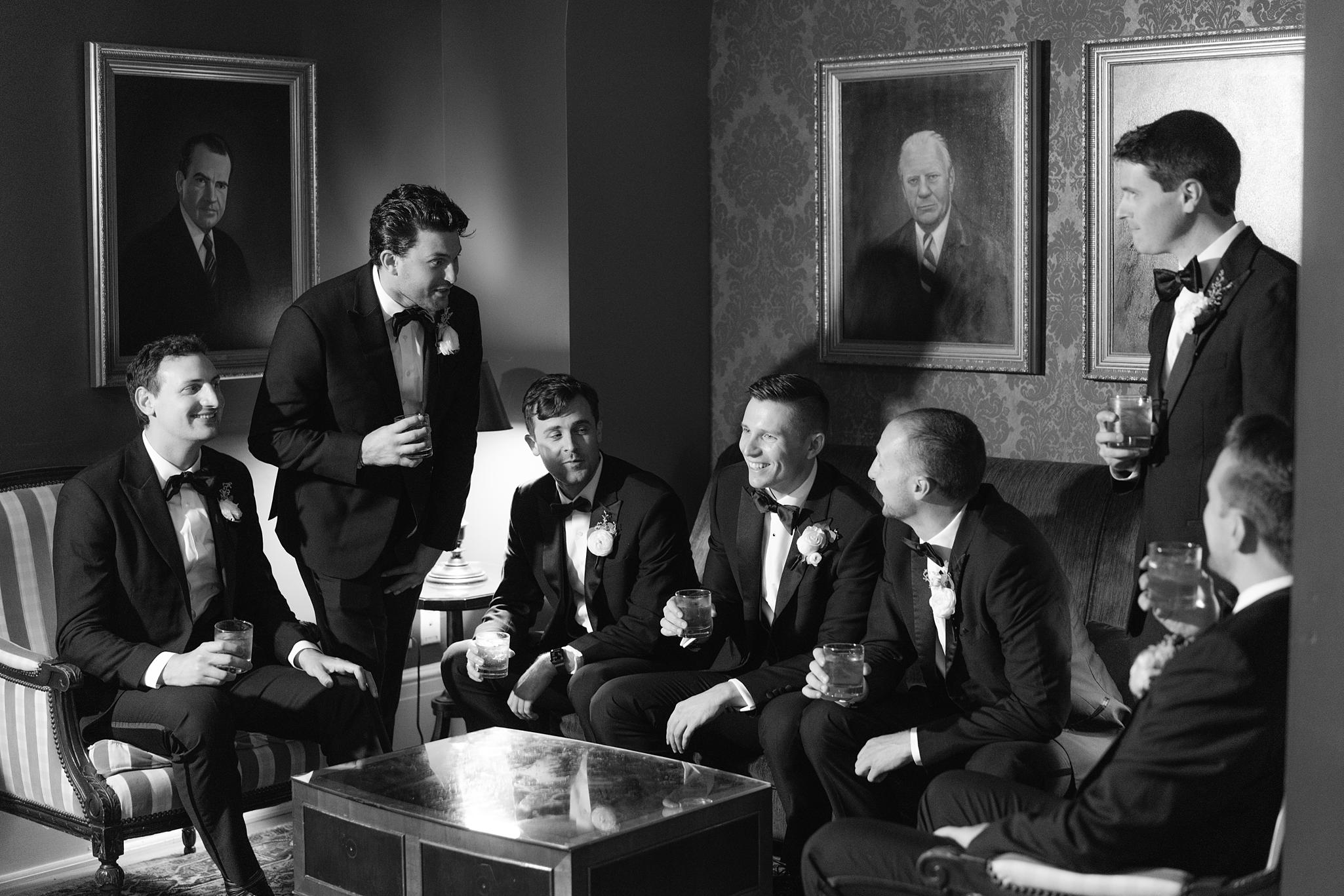 Groom and groomsmen sharing a drink together before his Omni Homestead Resort wedding.