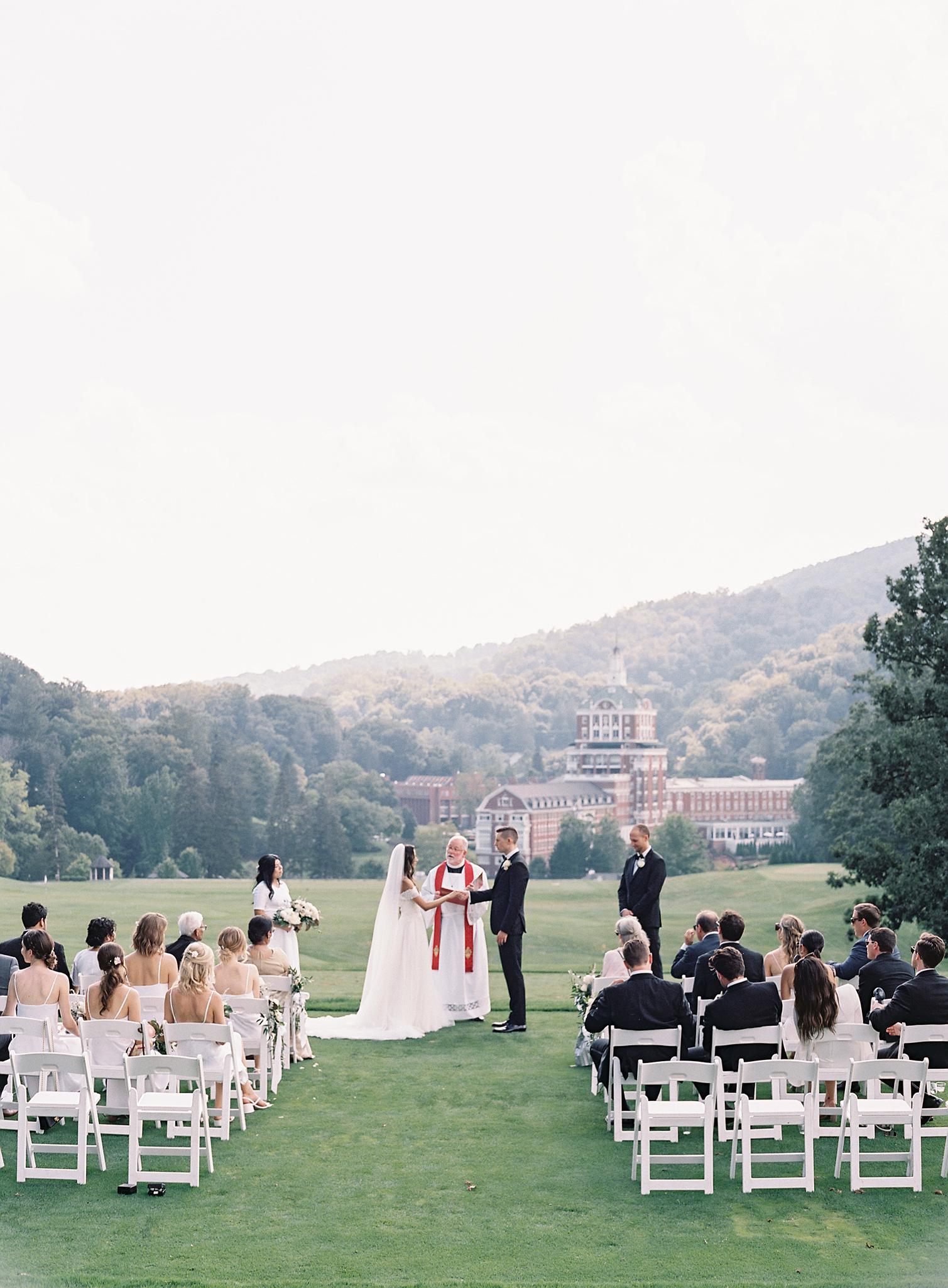 Wide shot of ceremony overlooking The Omni Homestead Resort.