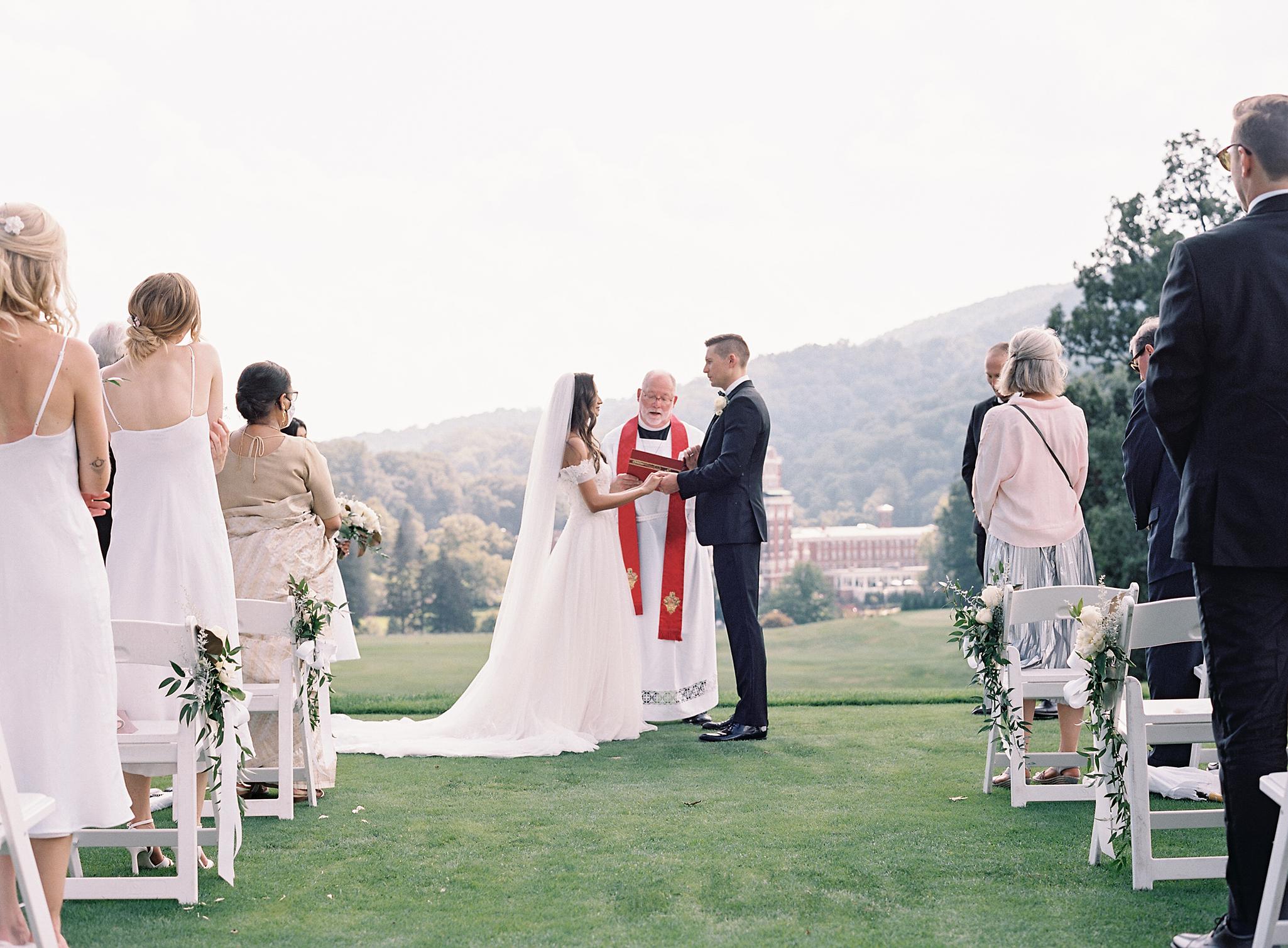 Bride and groom saying their vows at their Omni Homestead Resort wedding.