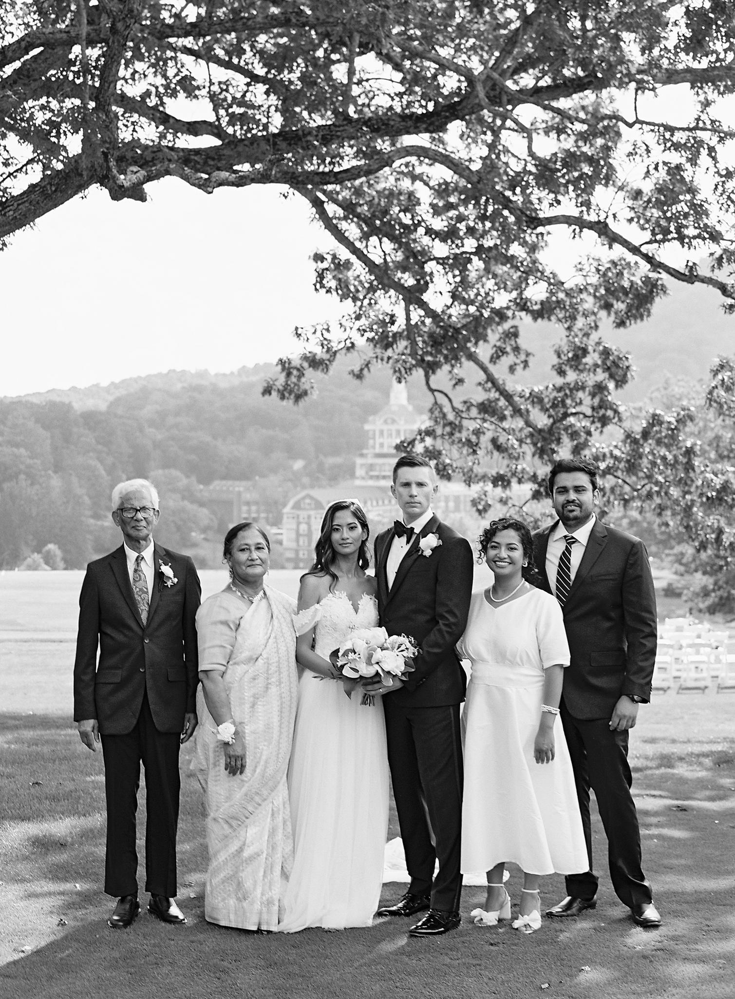 Bride and groom's family portrait at their Omni Homestead Resort wedding.