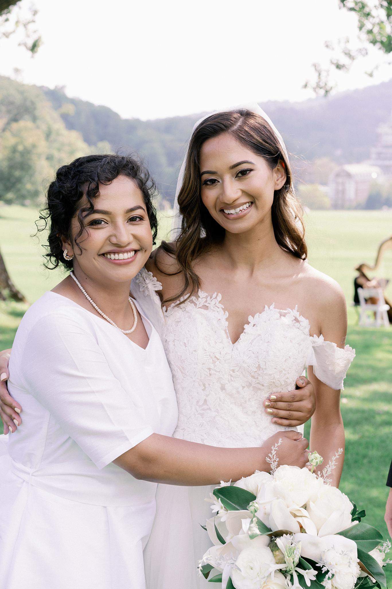 Bride and her sister embracing after her wedding at The Omni Homestead wedding.