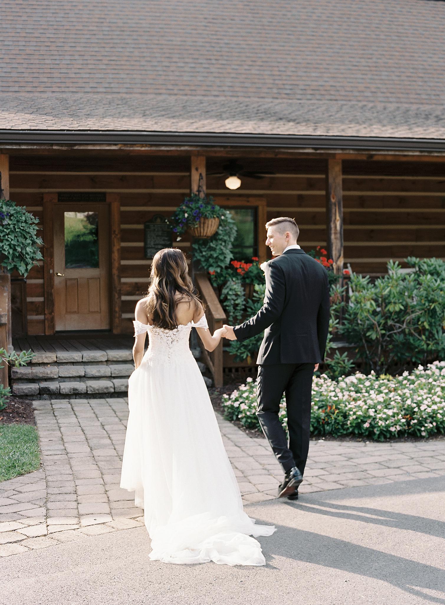 Bride and groom walking into to the reception together at The Omni Homestead Resort.