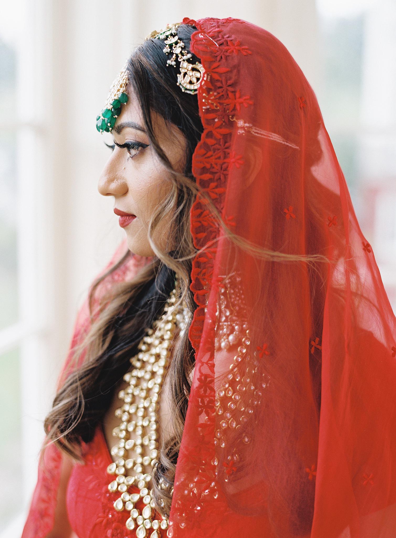 Portrait of Indian bride in her red sari at her Omni Homestead Resort wedding.