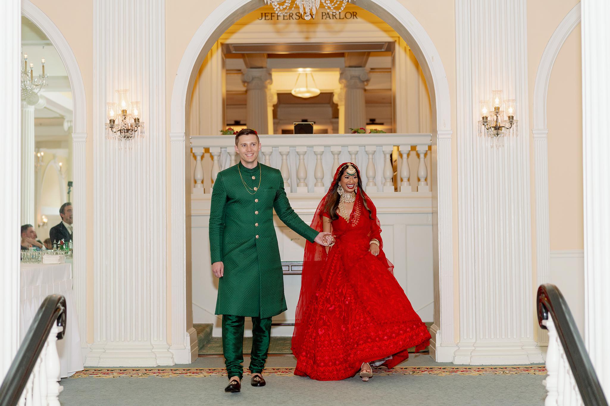 Bride and groom walking into their crystal ball room reception at their Omni Homestead Resort wedding.