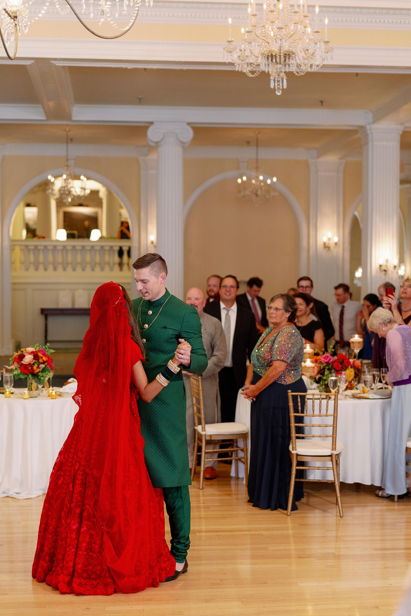 Bride and groom sharing their first dance in the crystal ball room at their Omni Homestead Resort wedding.