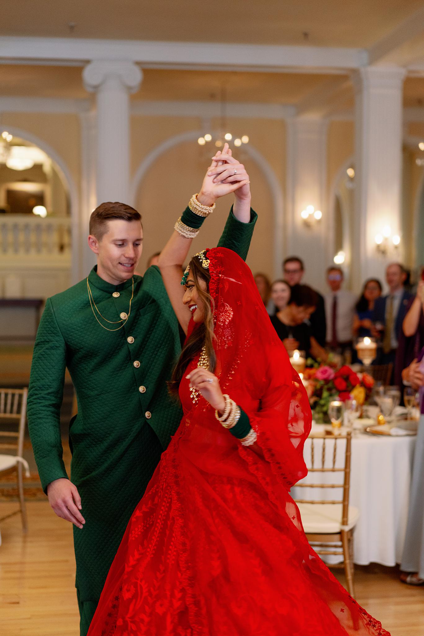 Bride and groom sharing their first dance in the crystal ball room at their Omni Homestead Resort wedding.