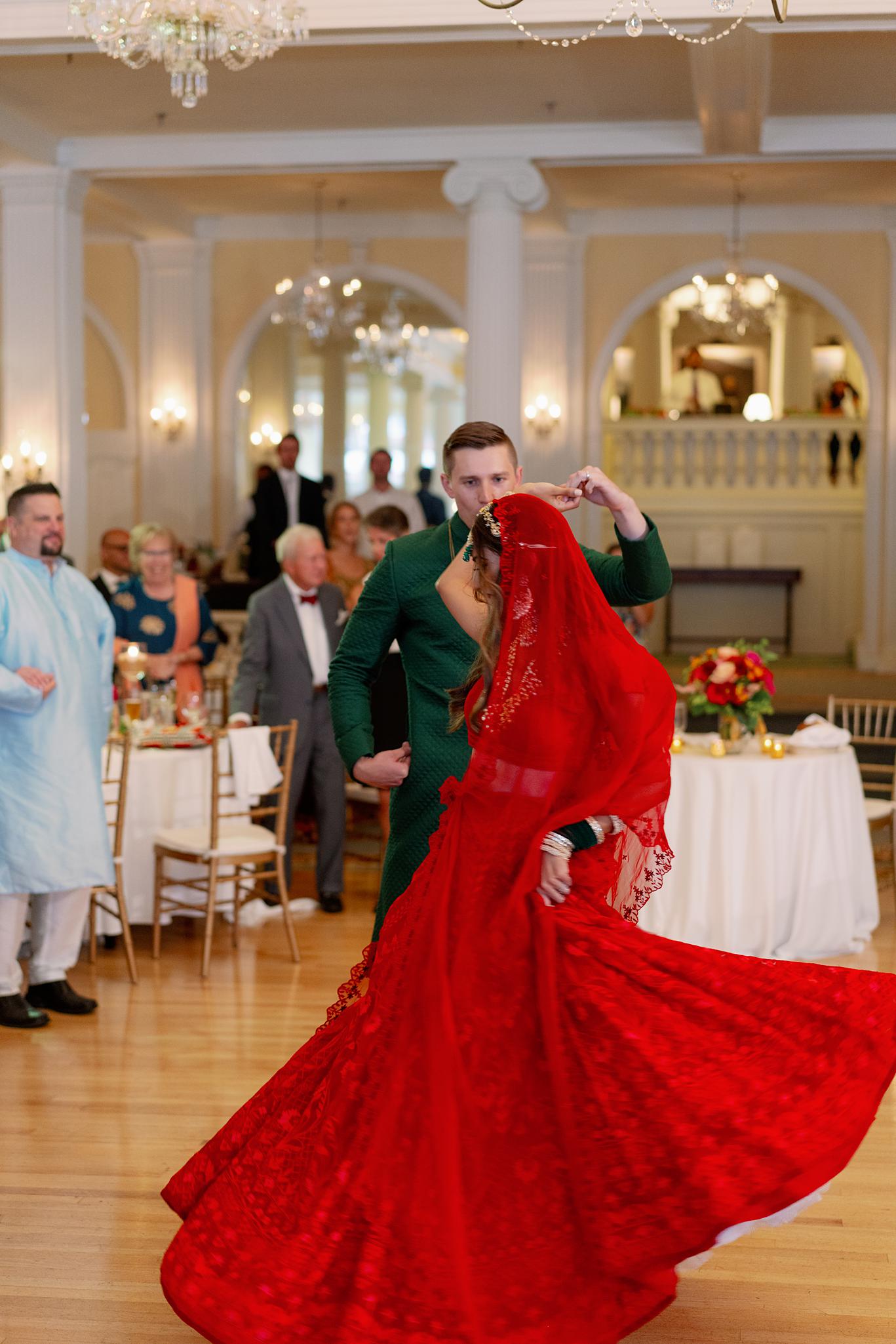 Bride and groom sharing their first dance in the crystal ball room at their Omni Homestead Resort wedding.