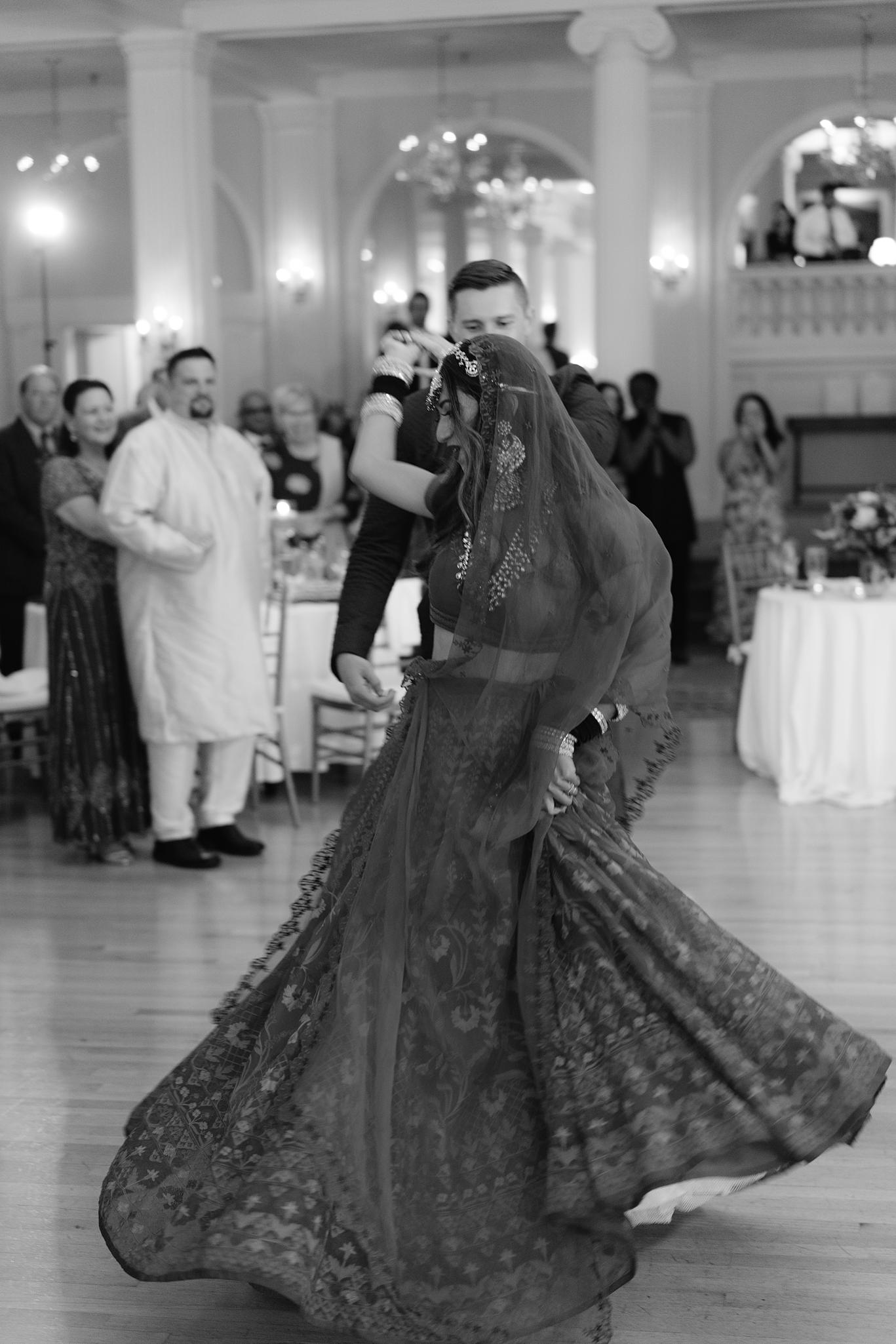 Bride and groom sharing their first dance in the crystal ball room at their Omni Homestead Resort wedding.