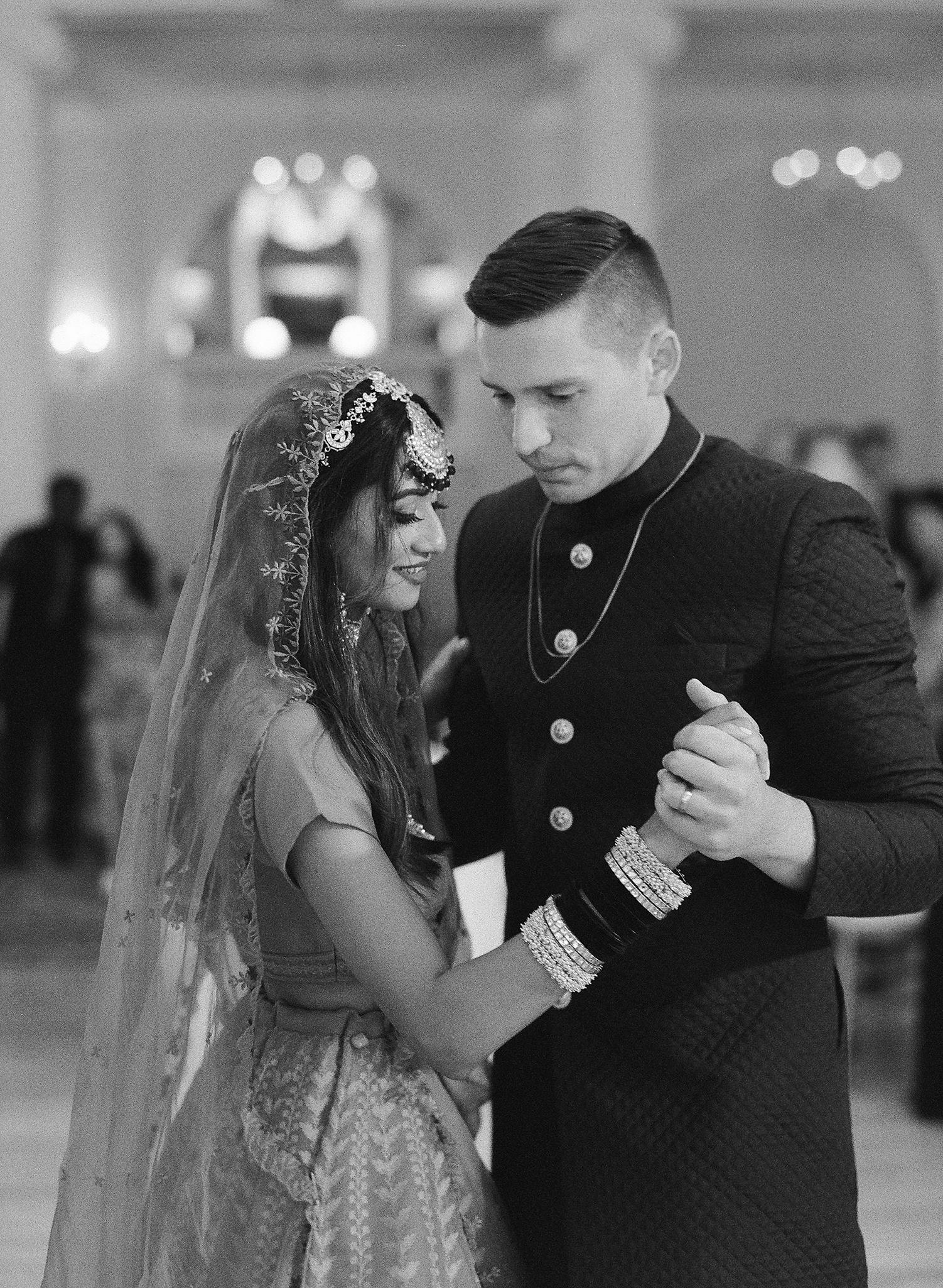 Bride and groom sharing their first dance in the crystal ball room at their Omni Homestead Resort wedding.