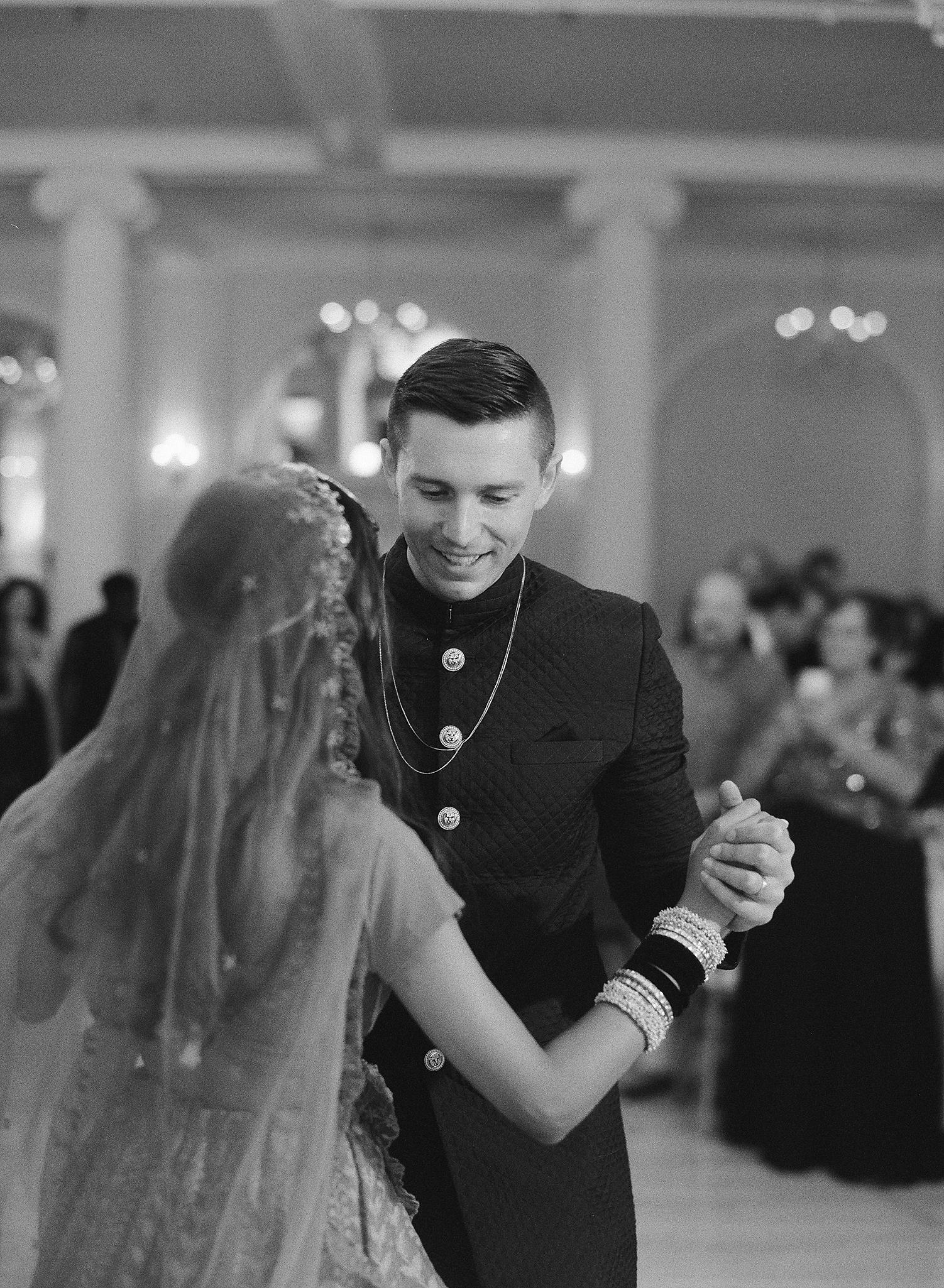 Bride and groom sharing their first dance in the crystal ball room at their Omni Homestead Resort wedding.