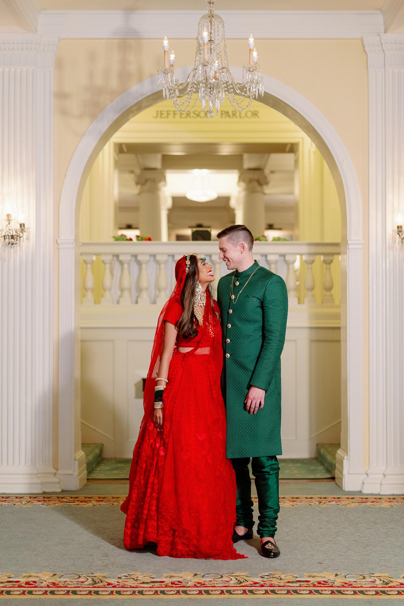 Bride and groom standing for portrait in their reception at The Omni Homestead Resort.