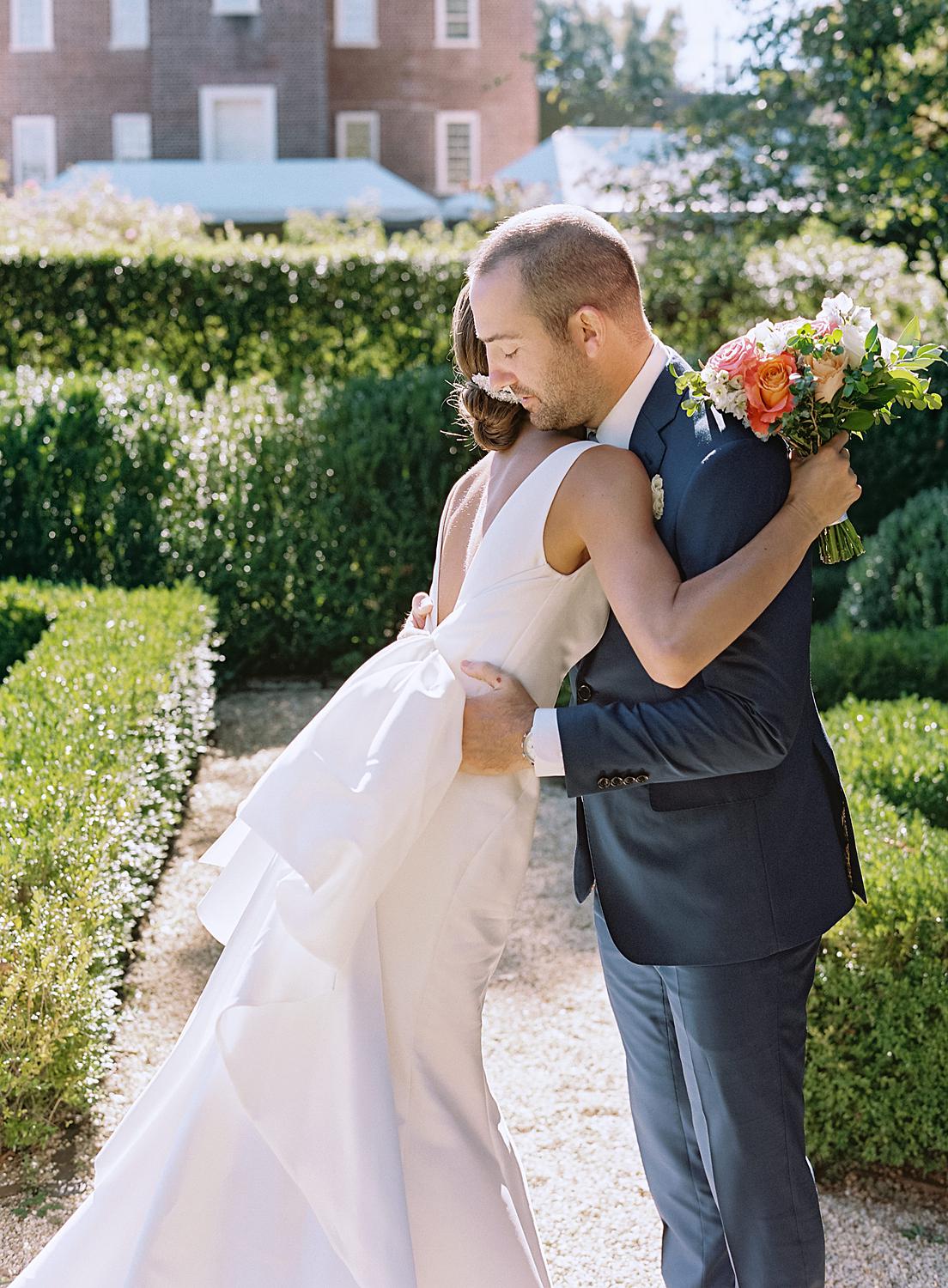 Bride and groom embracing during their first look.