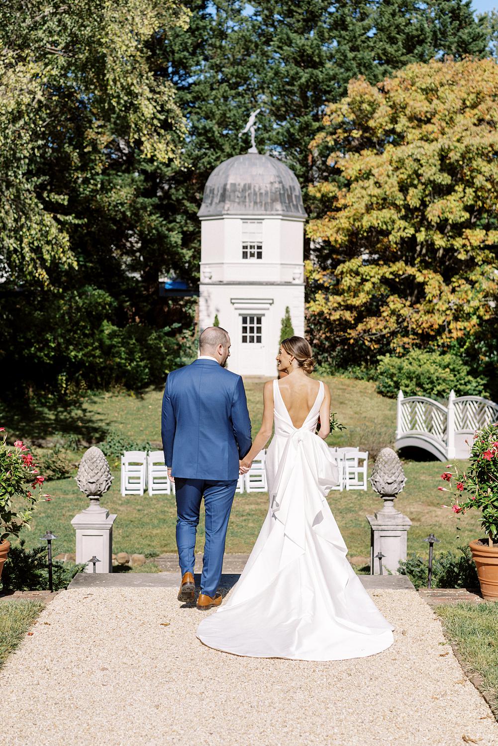 Bride and groom walking together after their first look at their William Paca House Wedding