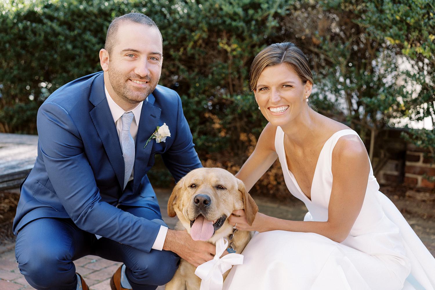 Bride and groom loving on their puppy during their William Paca House wedding in Annapolis.