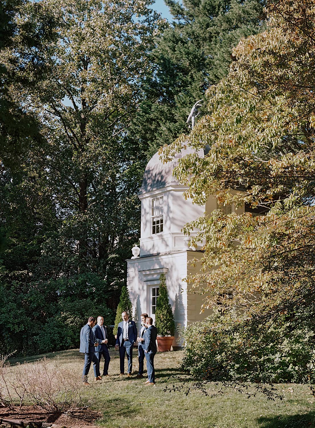 Groomsmen chatting together prior to the ceremony at The William Paca House and Gardens.