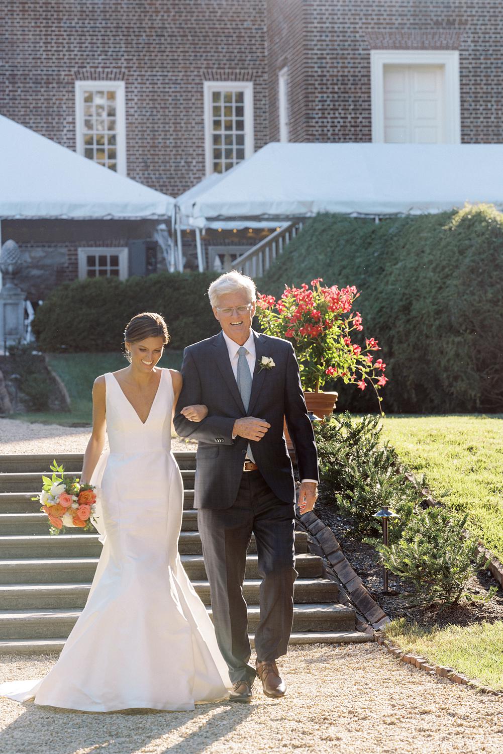 Father and bride walking down the aisle during there ceremony.