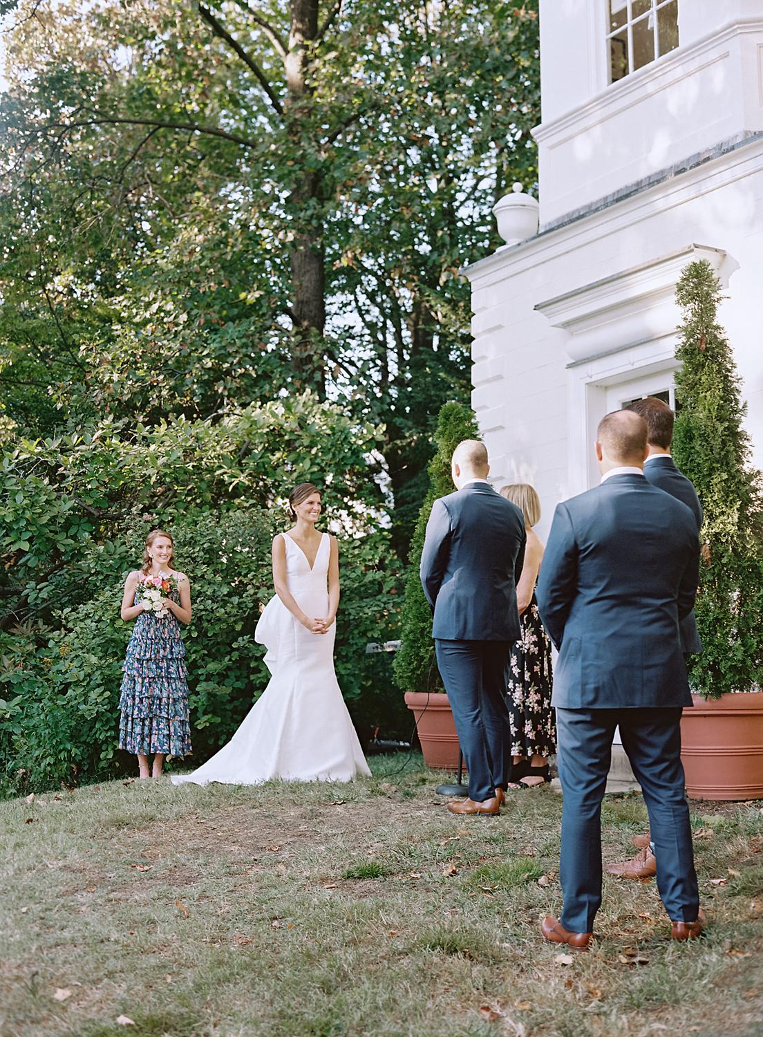 Bride and groom standing at the ceremony.