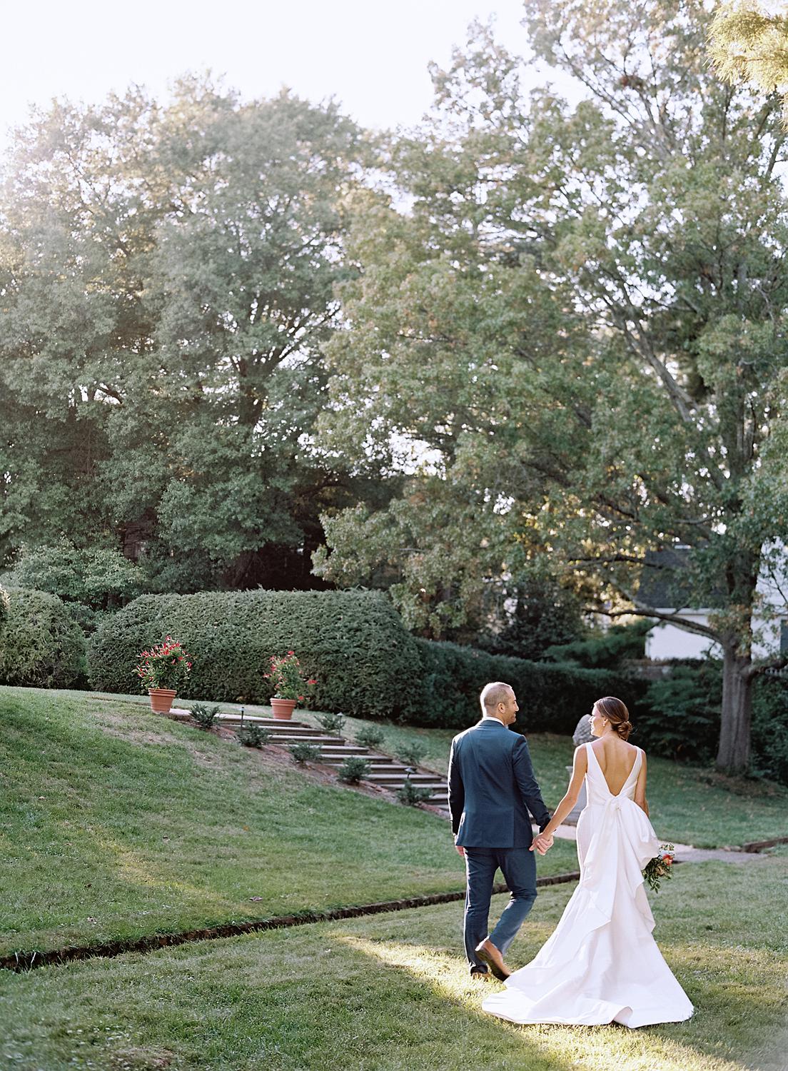 Bride and groom walking alway together in The William Paca House and Gardens.