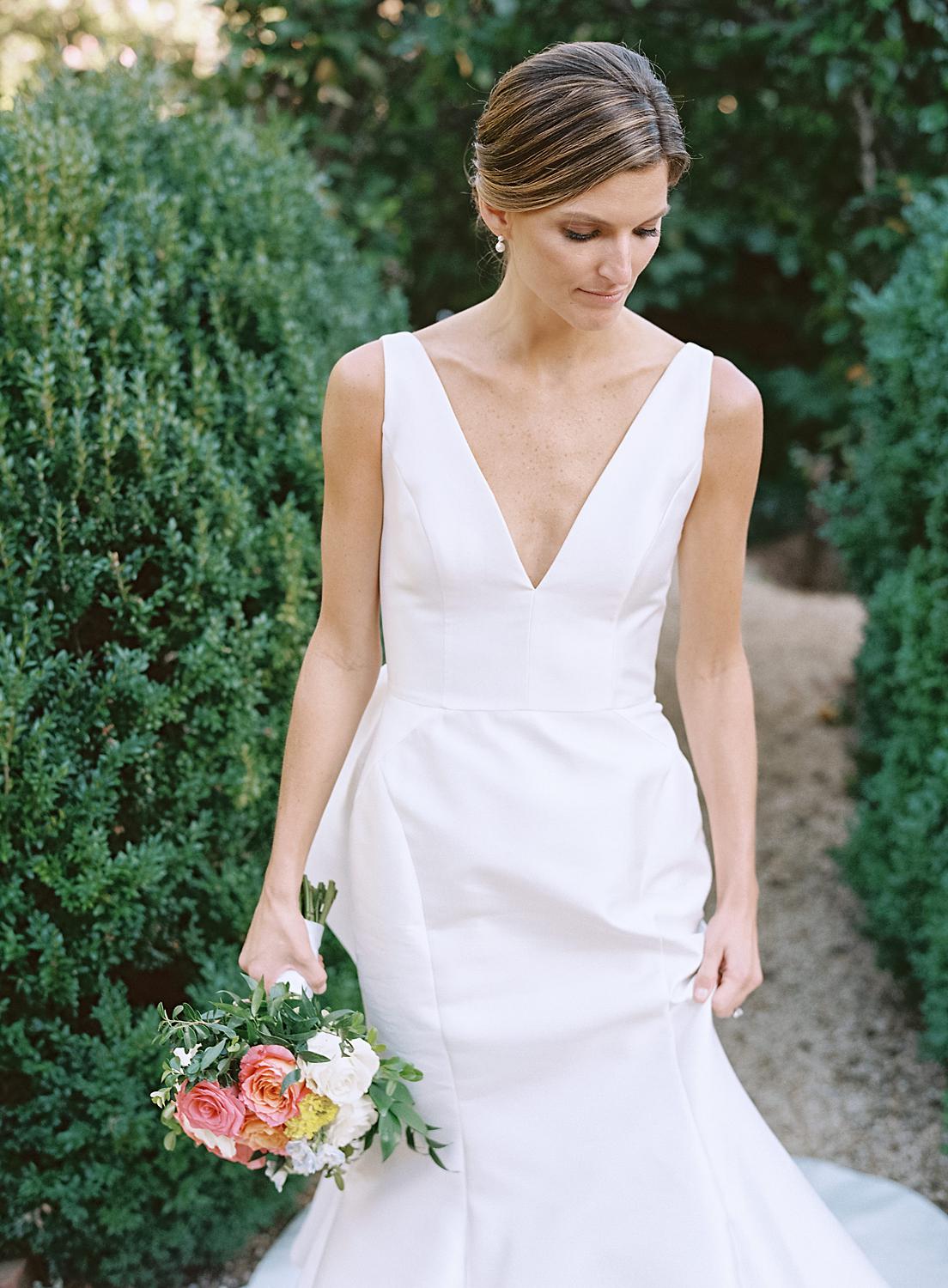 Bride holding her dress.